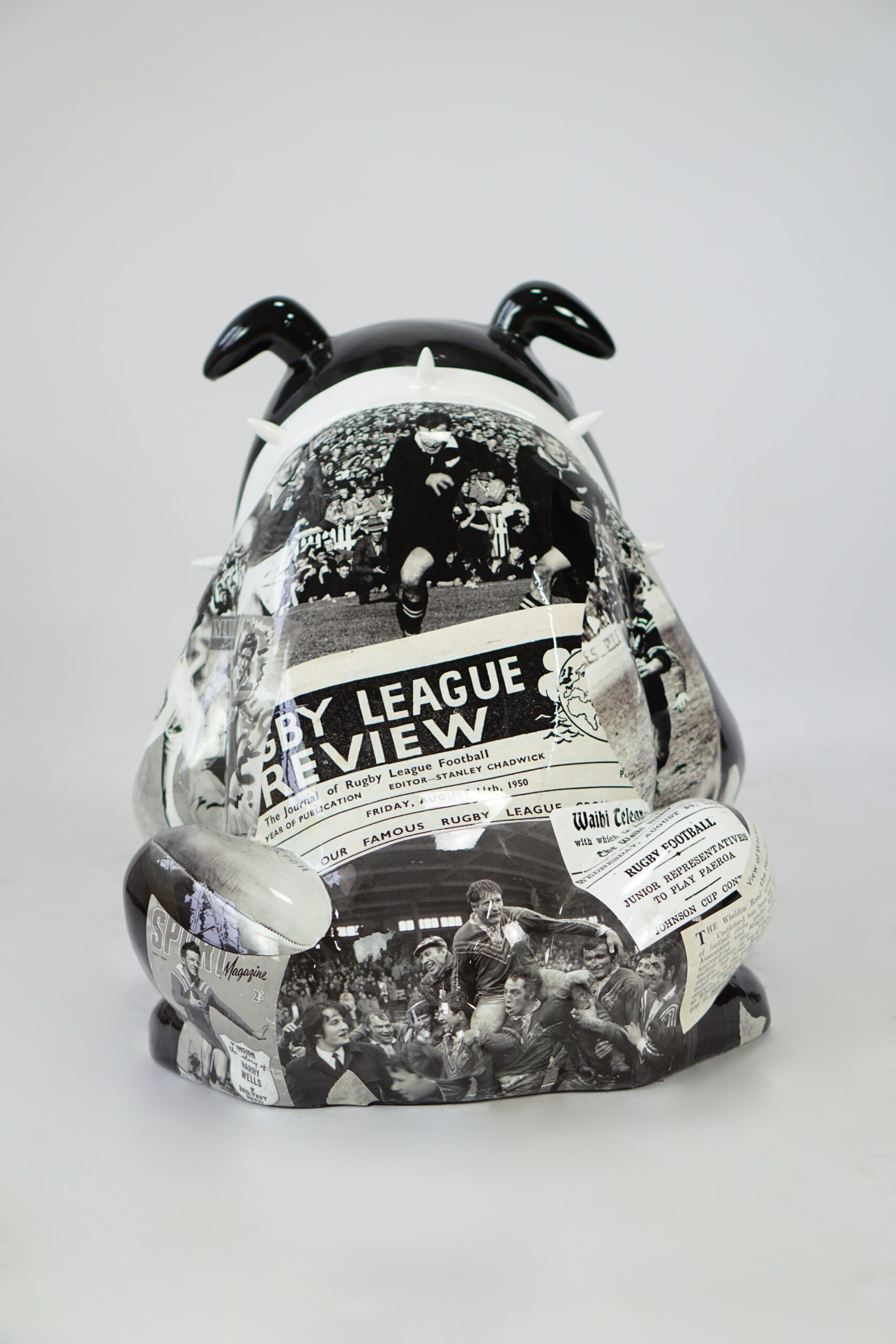 Bulldog Avella Dog 55cm - rugby 3 Sculpture of a bulldog with black and white rugby-themed images and text covering its body.