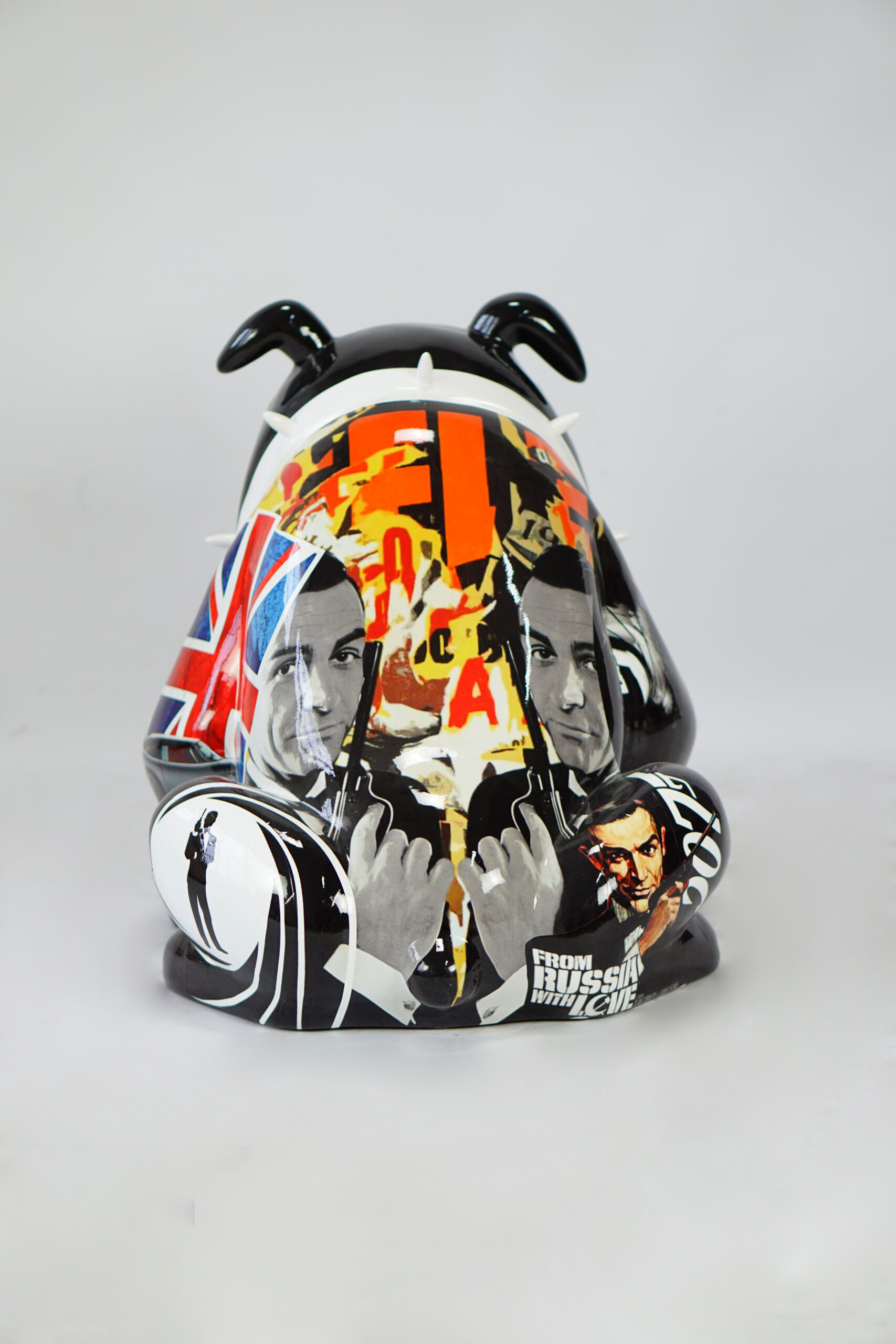 Bulldog Avella 55cm dog - James Bond 4 Decorative statue featuring a collage of a British flag, text, and figures resembling James Bond holding guns, with
