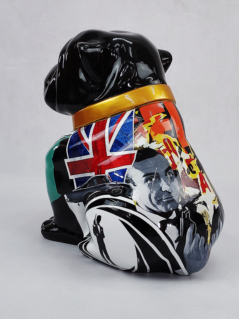 Bulldog Angelo 60cm dog - James Bond 3 A black ceramic dog figurine decorated with a collage of images, including a Union Jack flag and a portrait of a man in a suit holding a gun.