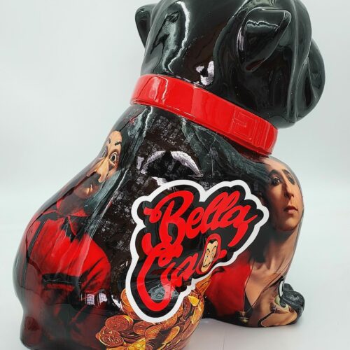 A black, glossy dog sculpture with a red collar, featuring images of TV show characters and the words 