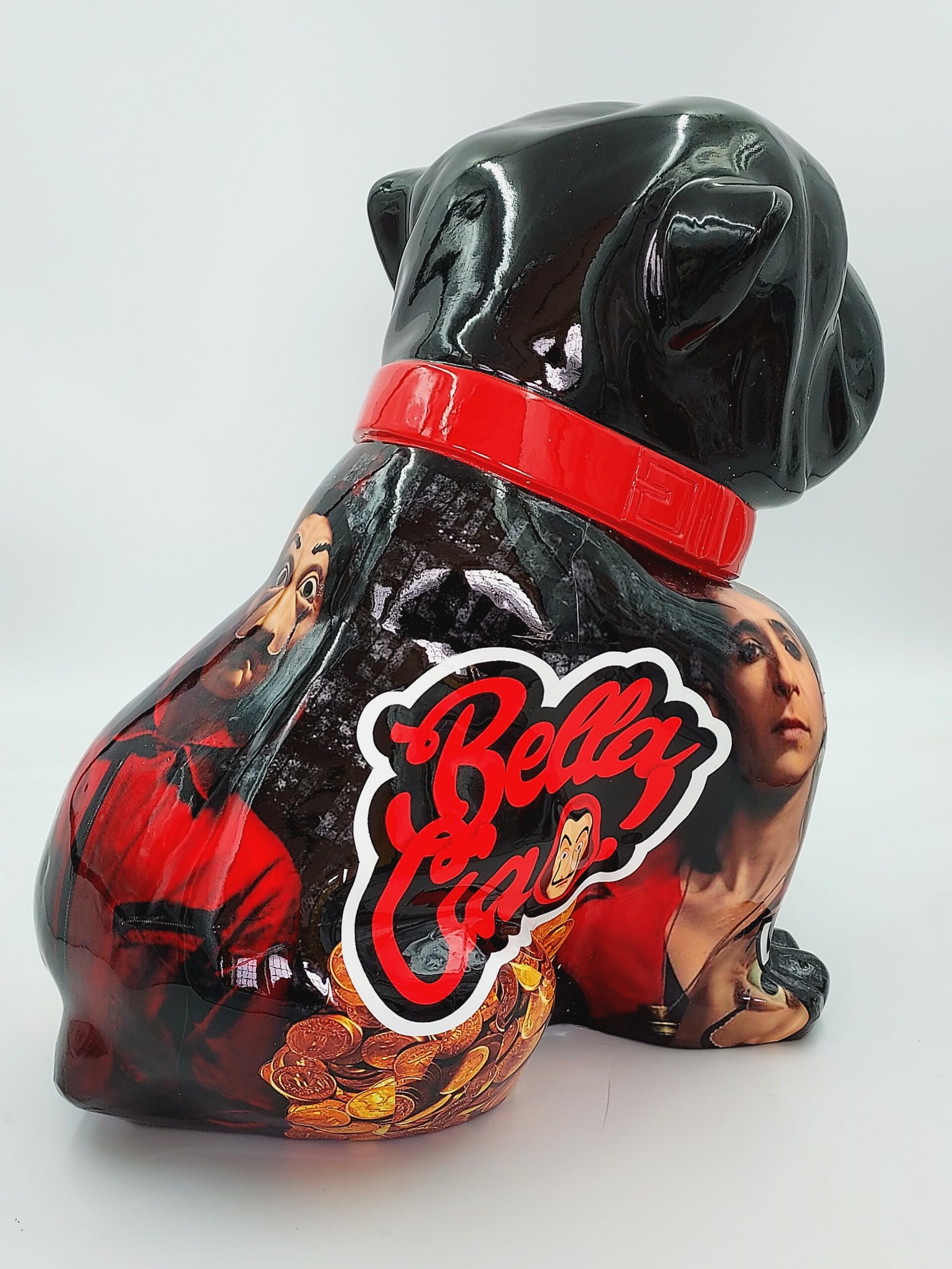 Bulldog Angelo 60cm dog - La Casa de Papel 3 A black, glossy dog sculpture with a red collar, featuring images of TV show characters and the words