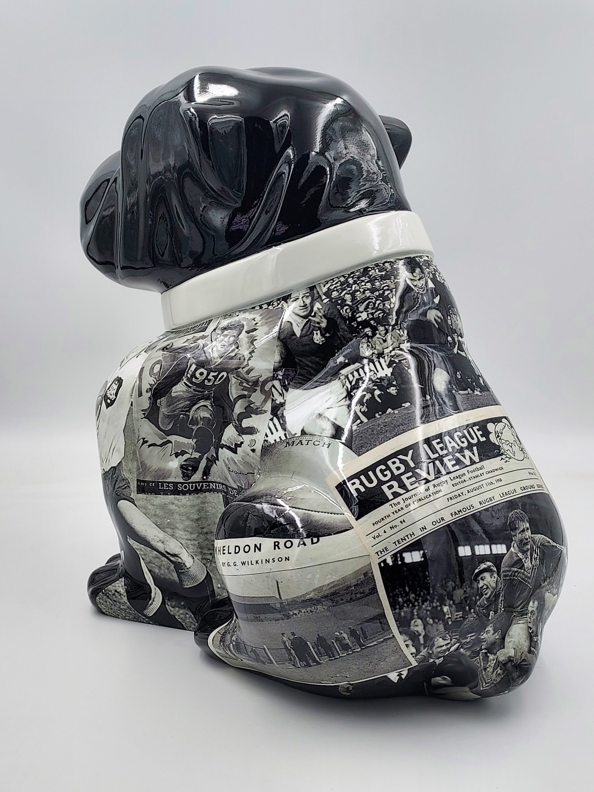 Bulldog Angelo 60cm dog - rugby 2 Black ceramic dog statue decorated with vintage newspaper clippings.