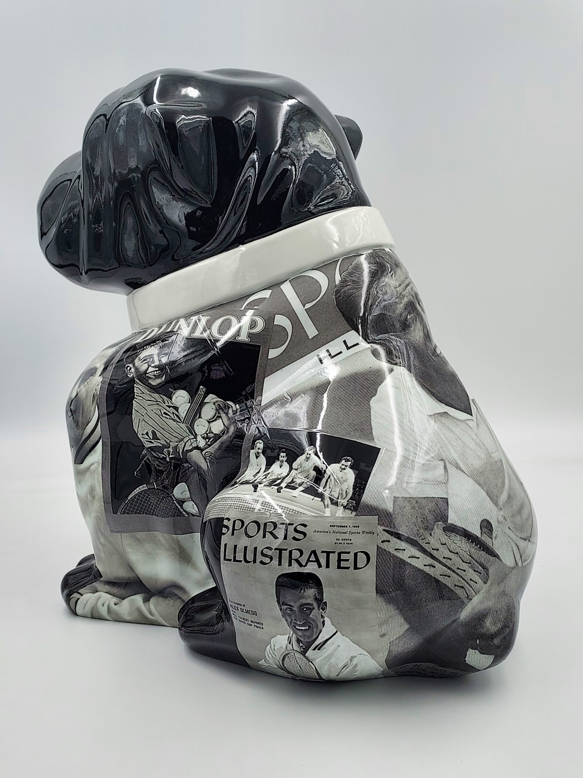 Bulldog Angelo 60cm dog - Tennis 2 Black and white ceramic dog sculpture featuring various tennis-themed magazine cutouts.