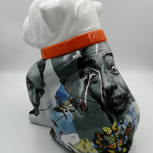 White ceramic dog sculpture decorated with surrealist images and an orange collar.