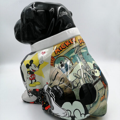 A decorative statue of a dog, featuring a black head and various Mickey Mouse comic illustrations on its body.