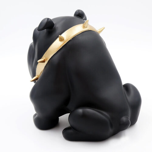Black bulldog figurine wearing a gold spiked collar, viewed from the back.