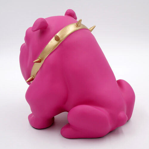A pink bulldog figurine wearing a gold spiked collar, viewed from behind.