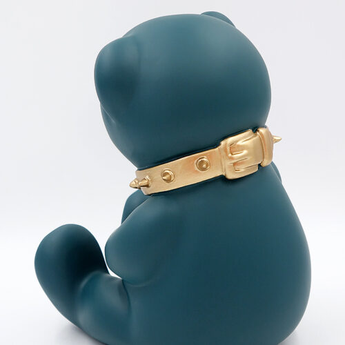 Dark green sculpture of a sitting bear wearing a gold spiked collar, viewed from the back.