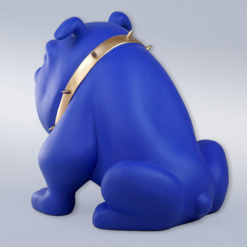 Blue bulldog sculpture with a gold spiked collar, seen from behind.