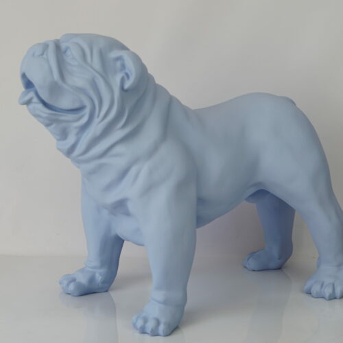 A light blue statue of an English bulldog standing on a smooth, reflective surface.
