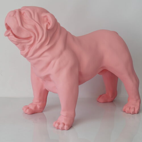 A pink statue of a bulldog standing with its mouth slightly open.