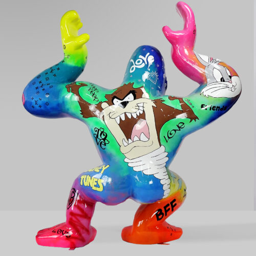 Colorful sculpture of a gorilla adorned with various graffiti-style artwork and cartoon characters, including the Tasmanian Devil and Bugs Bunny from Looney Tunes.