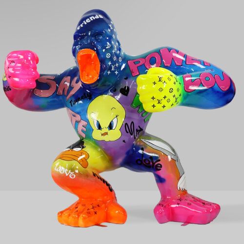 Colorful gorilla sculpture decorated with cartoon characters and words.