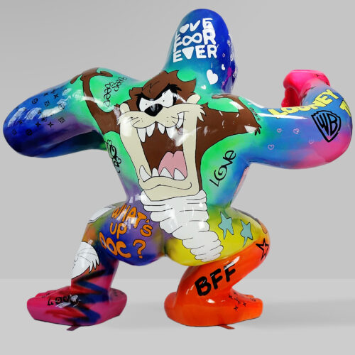 Colorful graffiti-style sculpture of a cartoon character with aggressive expression and various doodles and phrases.
