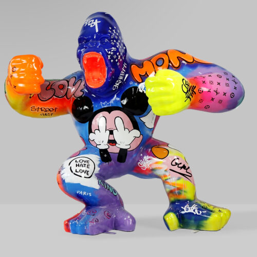 Colorful gorilla sculpture featuring various graffiti-style inscriptions, street art, and symbols, including a Mickey Mouse face with raised middle fingers on its torso.