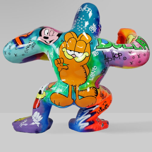Colorful sculpted figure with spray-painted graffiti, featuring a cartoon cat and various street art elements.
