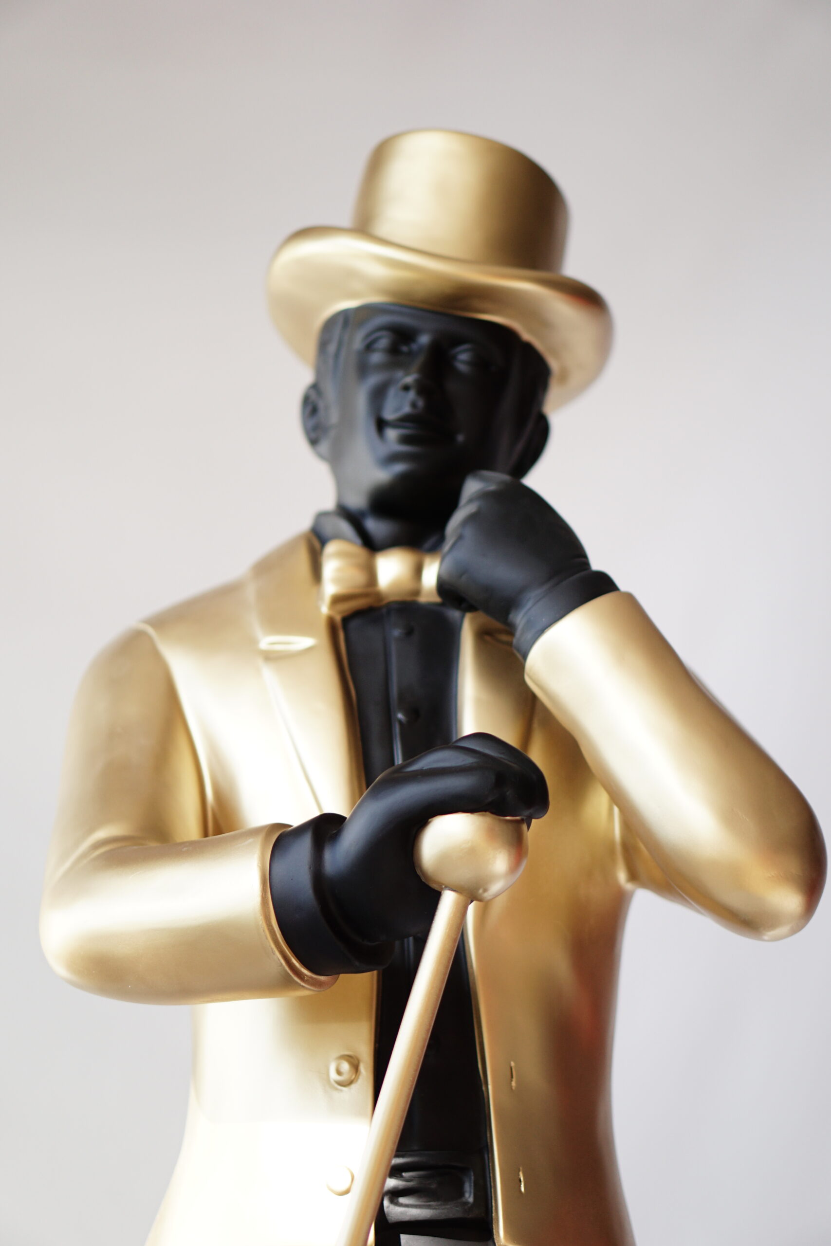 Johnnie Walker - keep walking 3 Statue of a man in a gold suit and top hat, holding a cane.