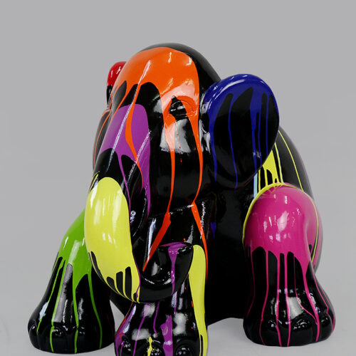 A colorful elephant figurine painted in black, adorned with drip patterns in vibrant colors including orange, purple, blue, green, yellow, and pink.