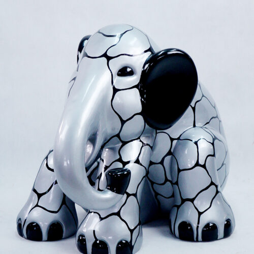 Silver elephant figurine with black ears, black feet, and a network of black lines on its body.