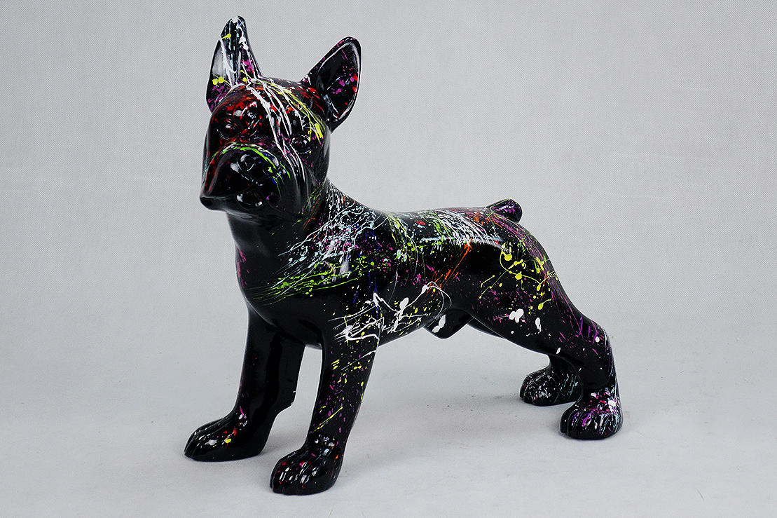 Bulldog Figi M - black splash 1 Artistic statue of a dog painted black with colorful splatters and streaks of neon paint.