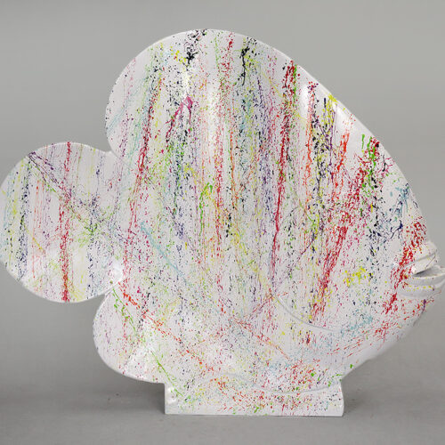 White abstract sculpture with colorful splatter paint.