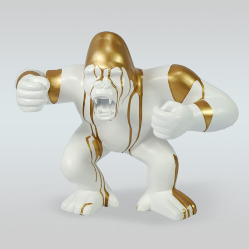 White gorilla sculpture with golden accents.