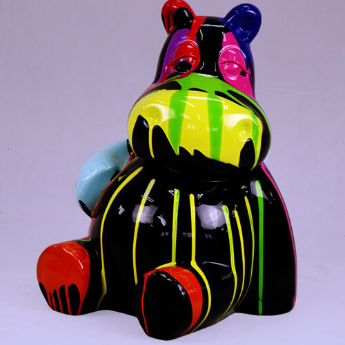 Colorful hippo figurine with black, yellow, green, red, blue, and pink stripes and patches, against a plain background.