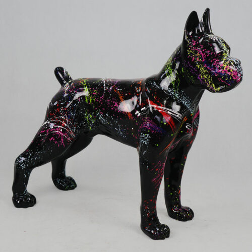 Black dog statue with vibrant, multicolored paint splatters, standing on a light gray background.