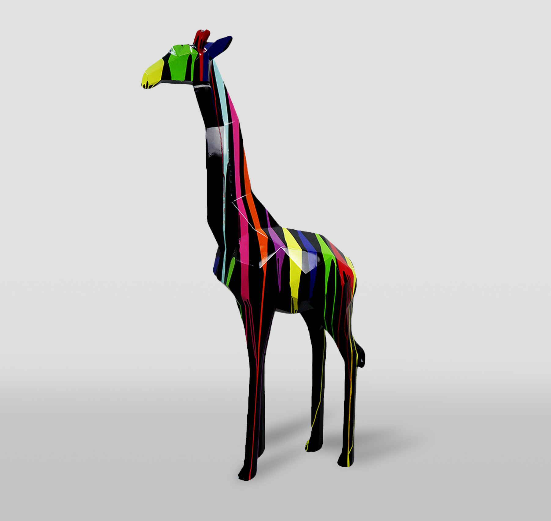 Large geometric giraffe figure made of laminate - black trash 1 Colorful abstract giraffe sculpture with geometric shapes and vibrant vertical stripes.