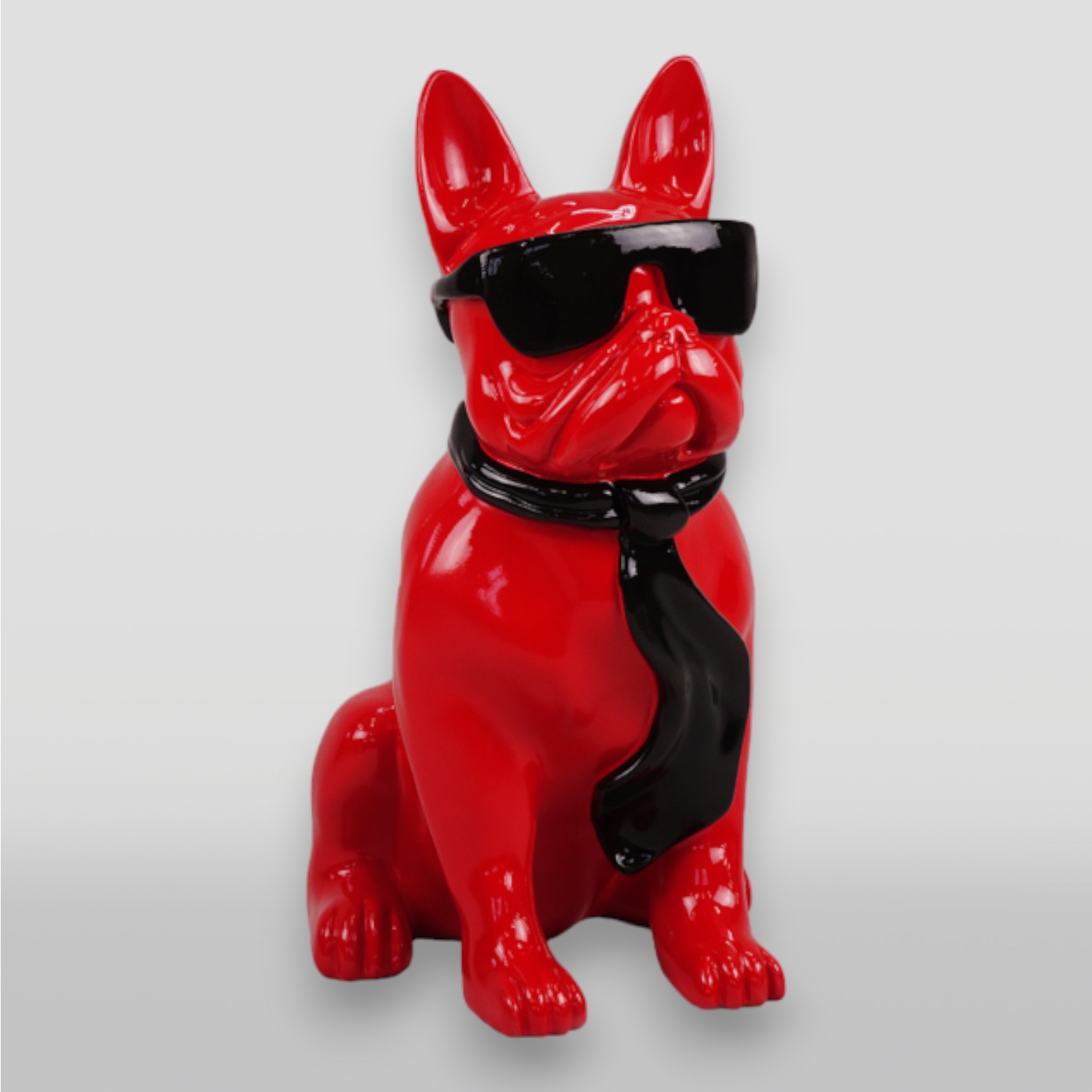 Small bulldog tie with glasses - one color 2 Red dog statue wearing black sunglasses and a black tie.