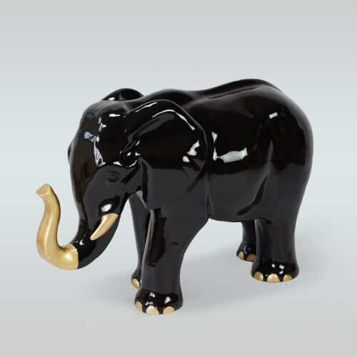Black ceramic elephant with golden tusks and toenails.
