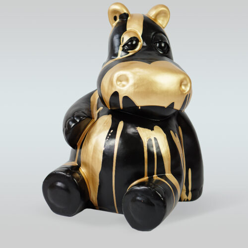 Black and gold hippo figurine with a glossy finish and dripping paint effect.