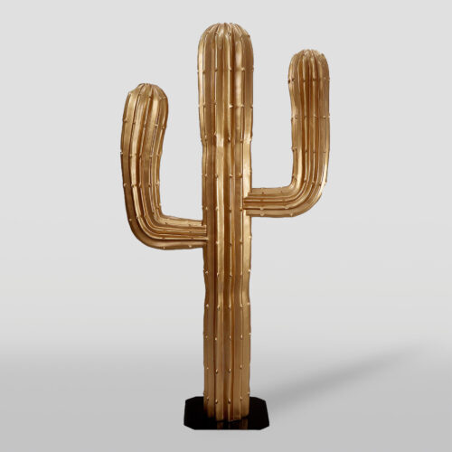 Golden cactus sculpture with three arms on a black base against a light background.