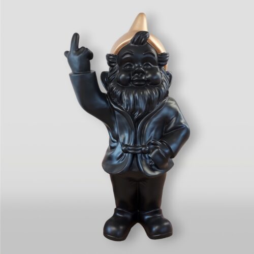 Black gnome statue with a golden hat and its left arm raised with its index finger extended.
