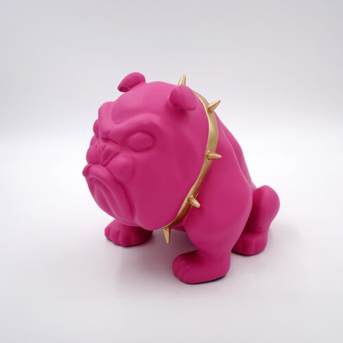 Pink bulldog figurine with a gold spiked collar against a white background.