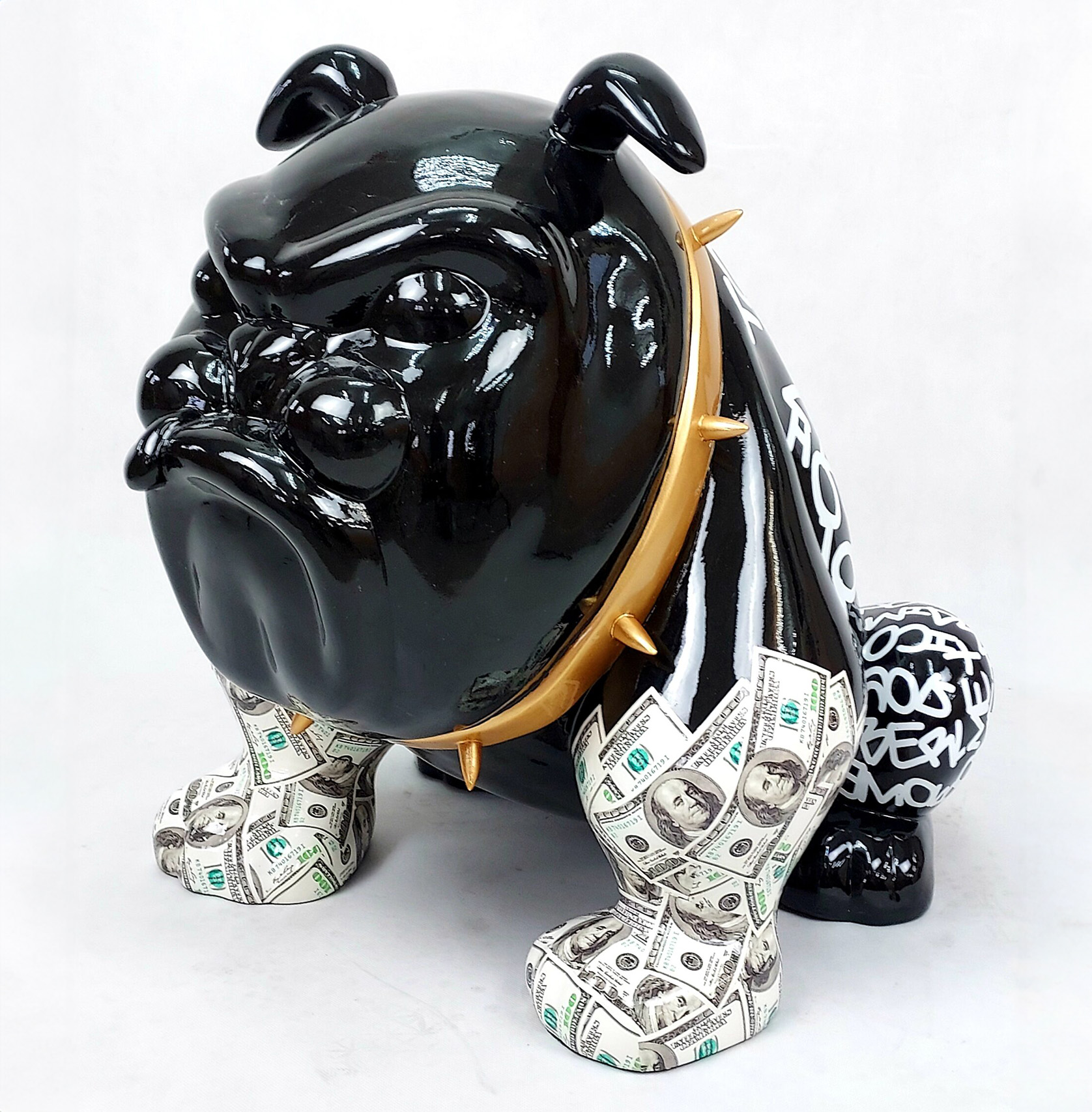 Bulldog Avella 55cm dog - Louis Paris 1 Sculpture of a black bulldog with a gold spiked collar, legs covered in dollar bills, and graffiti-style text on its rear.