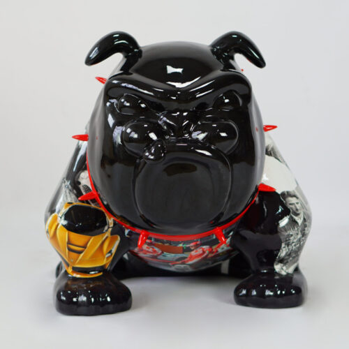 A black ceramic bulldog statue with a red spiked collar, featuring images of a car and black-and-white portraits on its body.