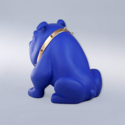 A statue of a blue dog with a gold spiked collar, facing away.