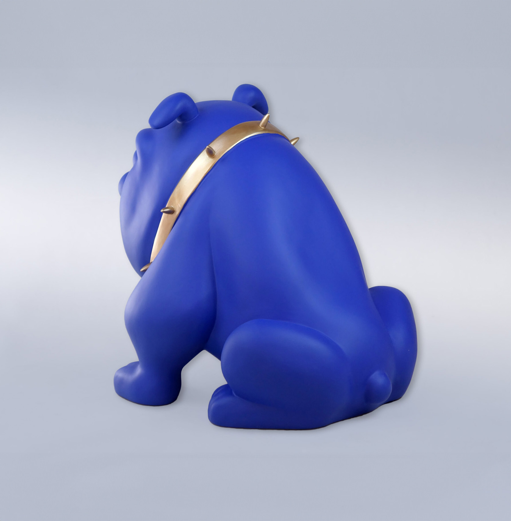 Bulldog Avella dog 22cm - blue mat 2 A statue of a blue dog with a gold spiked collar, facing away.