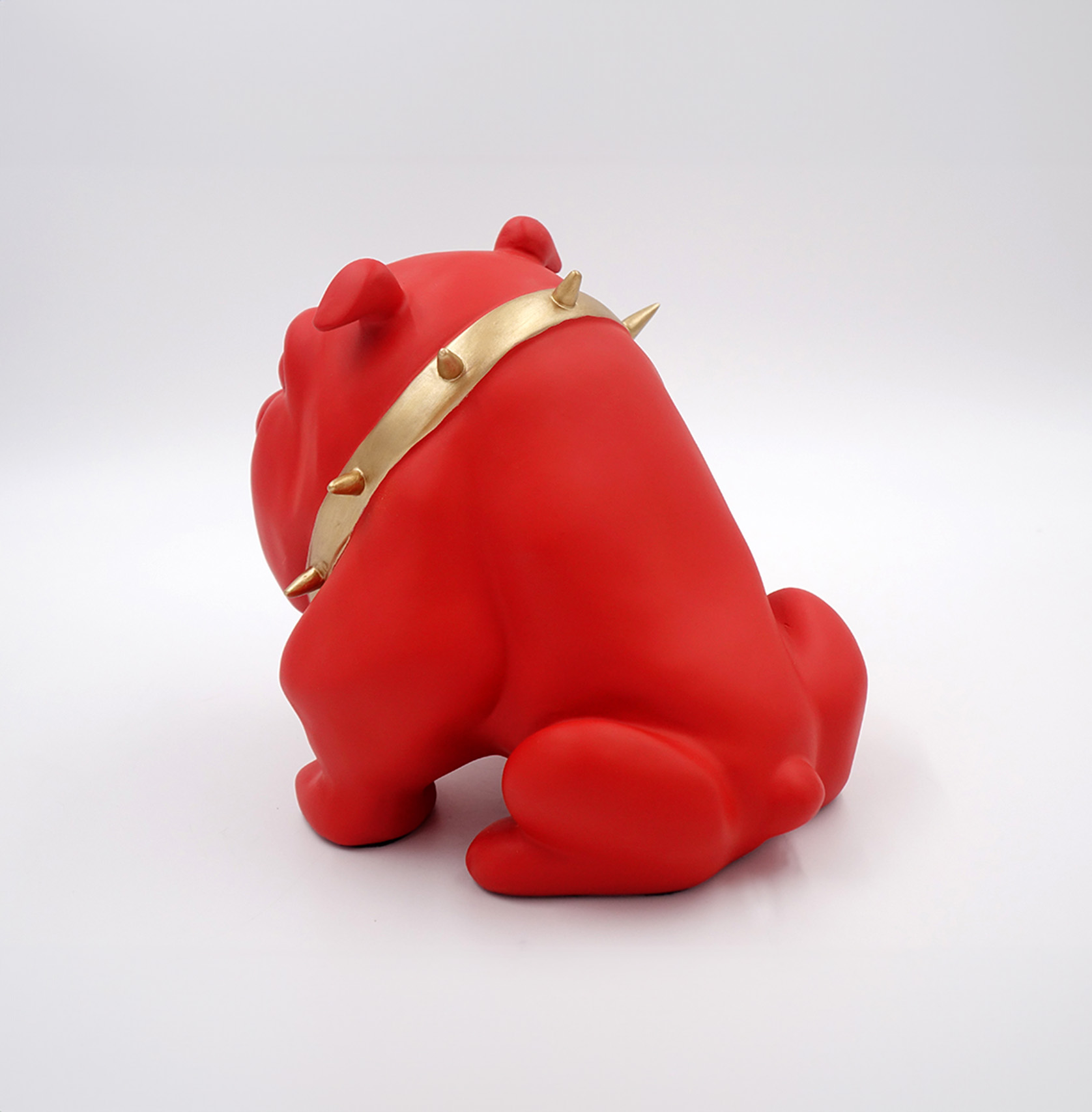 Bulldog Avella dog 22cm - red mat 2 Red bulldog sculpture wearing a gold spiked collar.