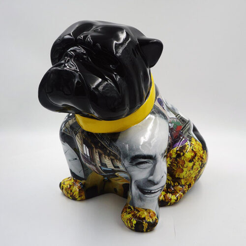 Glossy black bulldog sculpture with a collage of images on its body and a yellow collar.