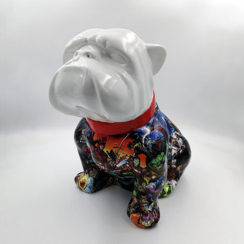 Ceramic bulldog figurine with a white head and a body decorated with colorful comic book superhero designs, wearing a red collar.