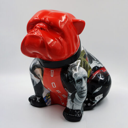Colorful bulldog statue with a glossy red head and a body featuring various black-and-white and colored images, including a man's face, racing elements, and the word 
