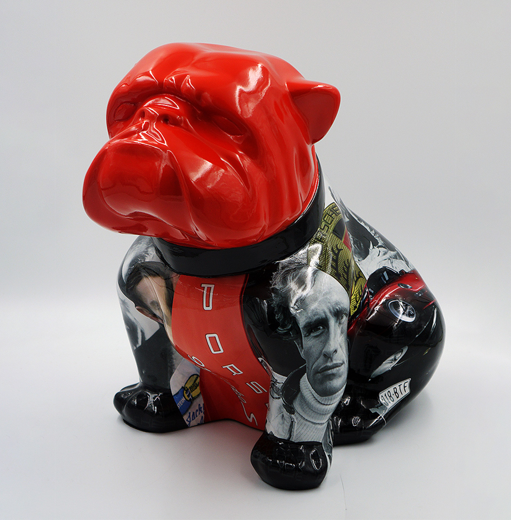 Bulldog Angelo 60cm dog - Porsche 1 Colorful bulldog statue with a glossy red head and a body featuring various black-and-white and colored images, including a man's face, racing elements, and the word