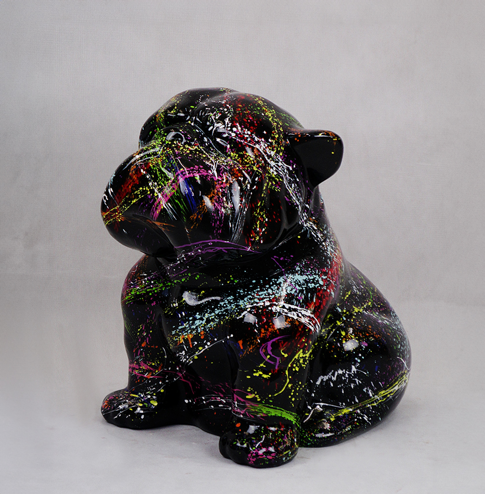 Bulldog Angelo 40cm dog - SPLASH 1 A black ceramic bulldog figurine with colorful splatter paint design.