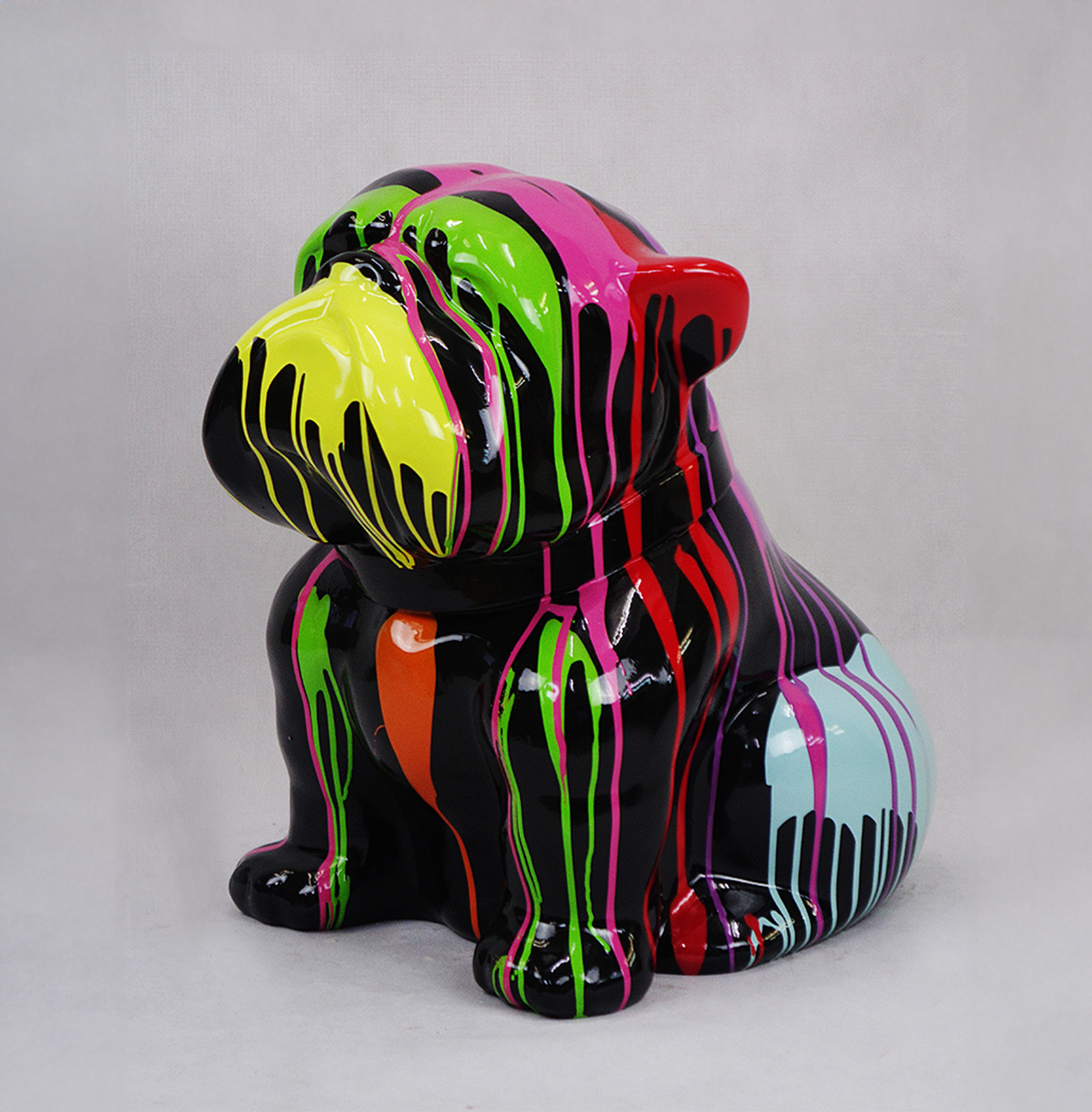 Bulldog Angelo 40cm dog - trash 1 Colorful bulldog sculpture with dripping paint effect in vibrant shades of yellow, green, pink, orange, red, and blue on a black base.