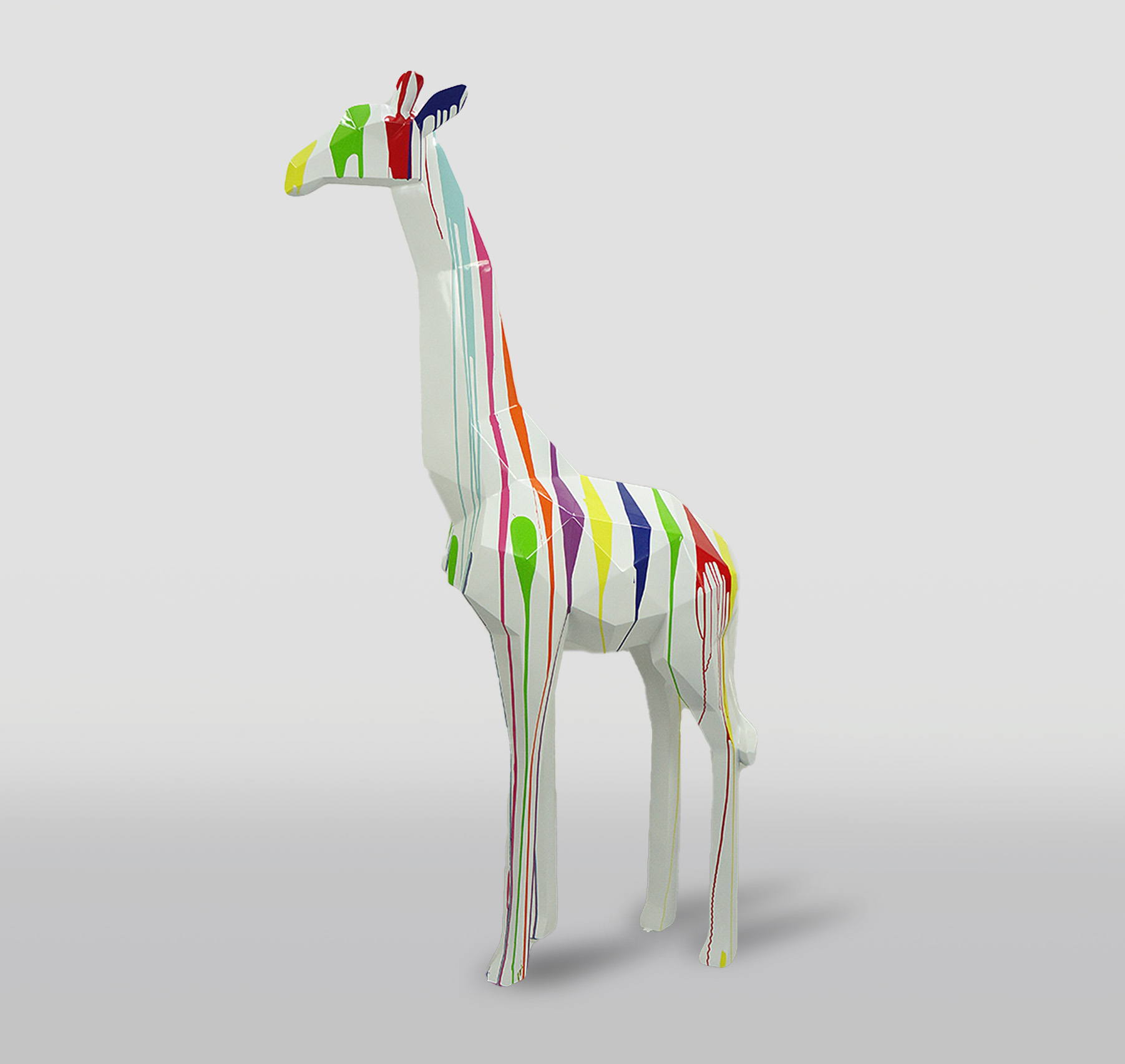 Large geometric giraffe figure made of laminate - black trash 2 A colorful giraffe sculpture with a white base and multicolored paint drips covering its body.