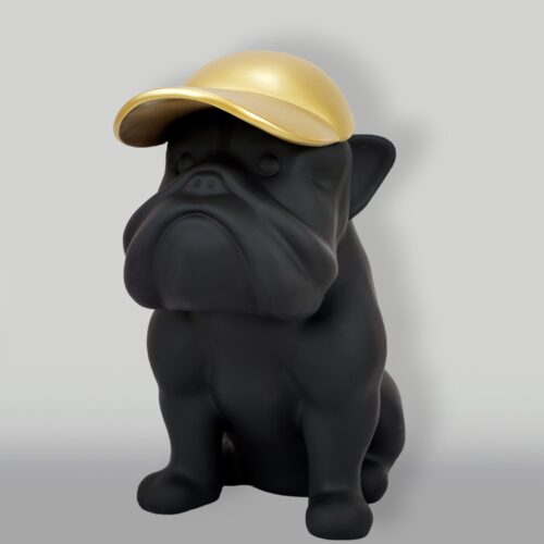 Black bulldog statue wearing a gold cap.