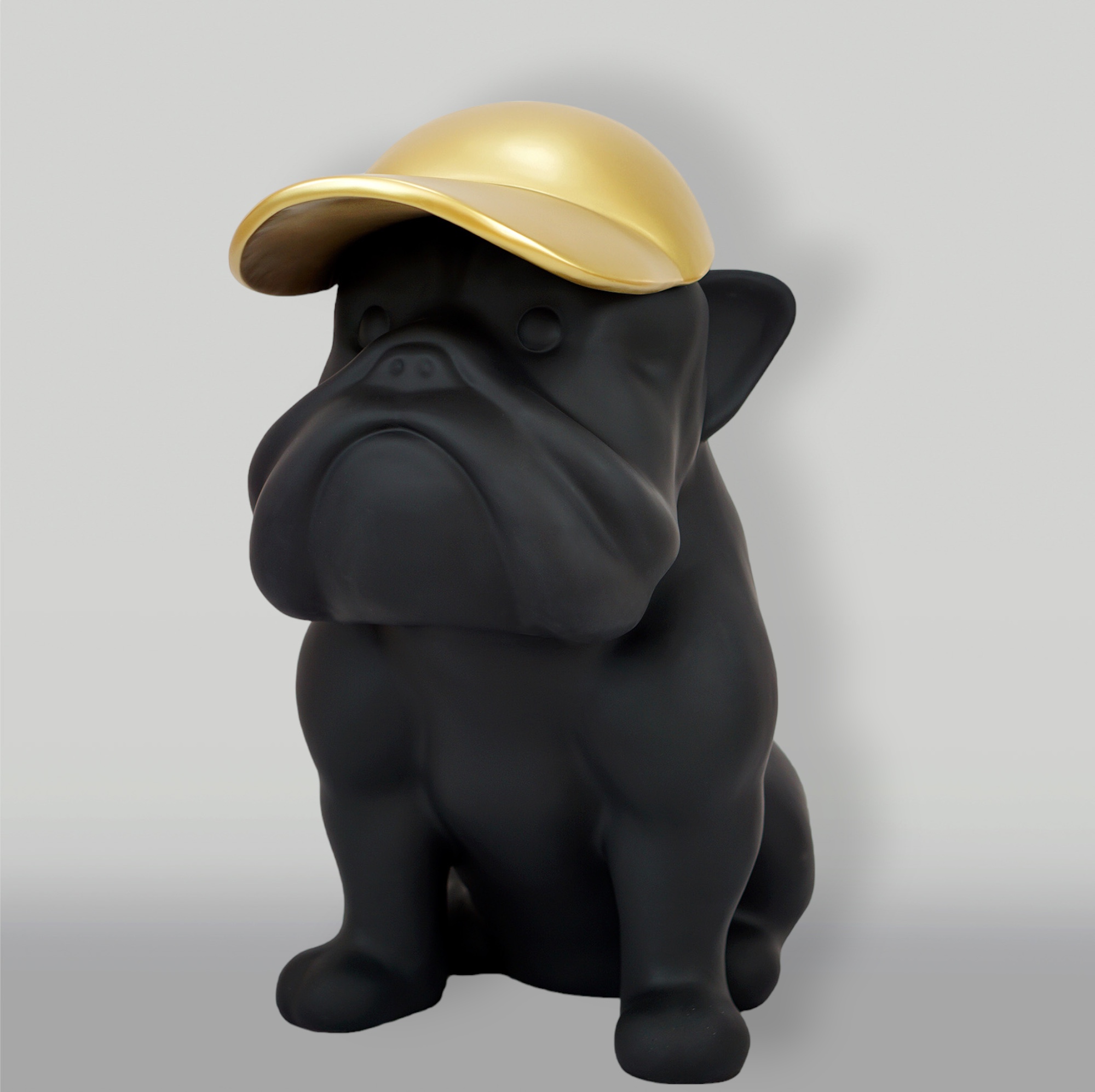 Bulldog with cap - matte painted 1 Black bulldog statue wearing a gold cap.