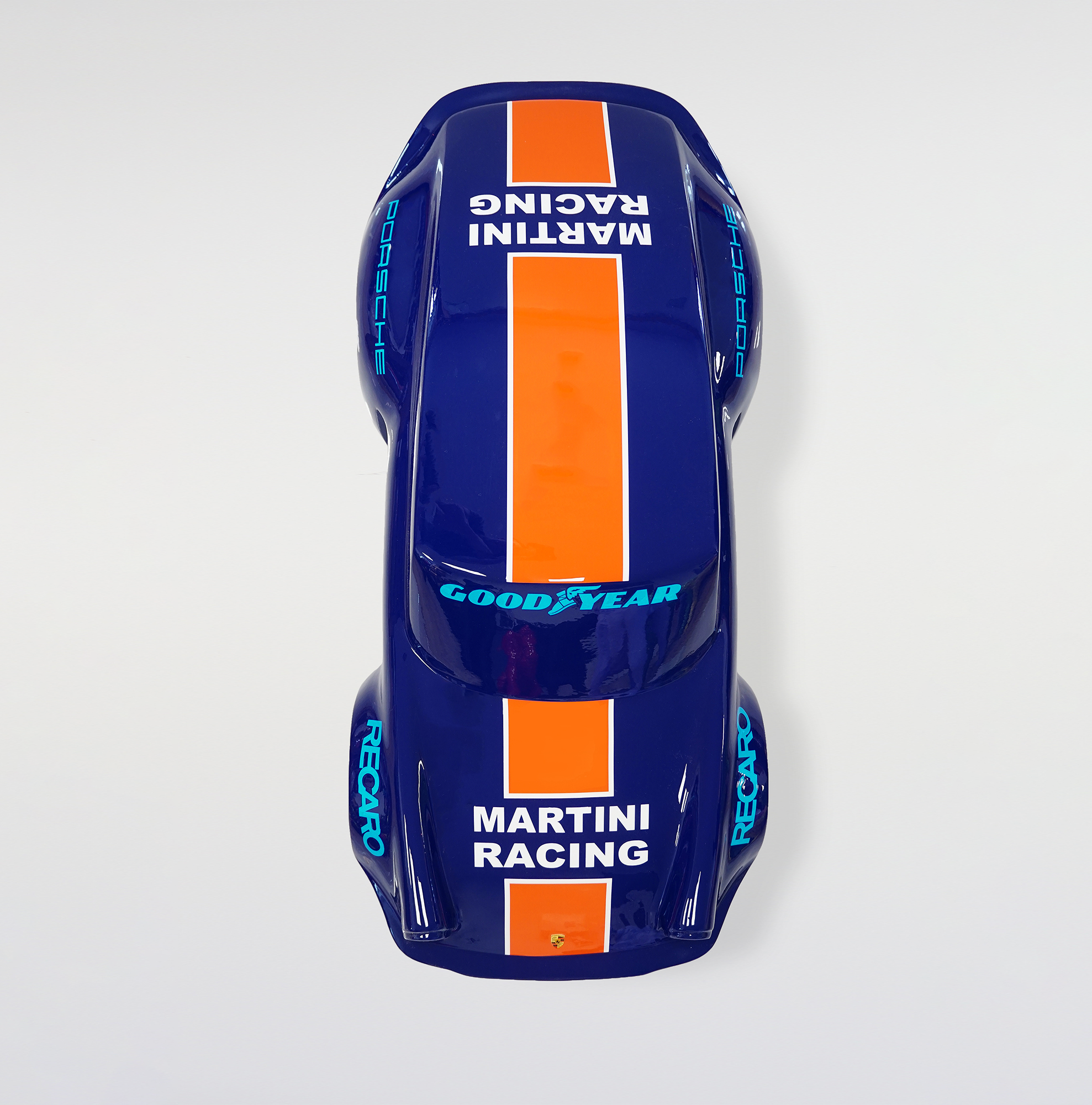 Car model 911 - motif 23 3 Overhead view of a blue toy race car with orange racing stripes, featuring the logos